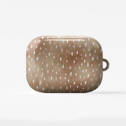Fawn Fleck AirPods case in warm beige with irregular tan speckles and organic abstract marks.