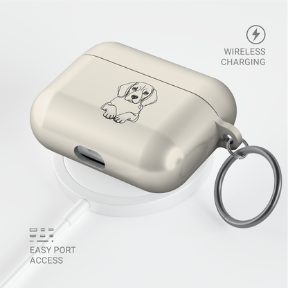 Angled Cream Beagle AirPods case with a metal keyring, shown above a circular charging pad.