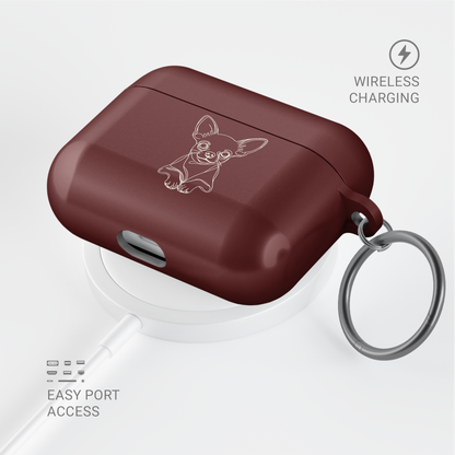 Angled Claret Red Chihuahua AirPods case with a metal keyring, shown above a circular charging pad.