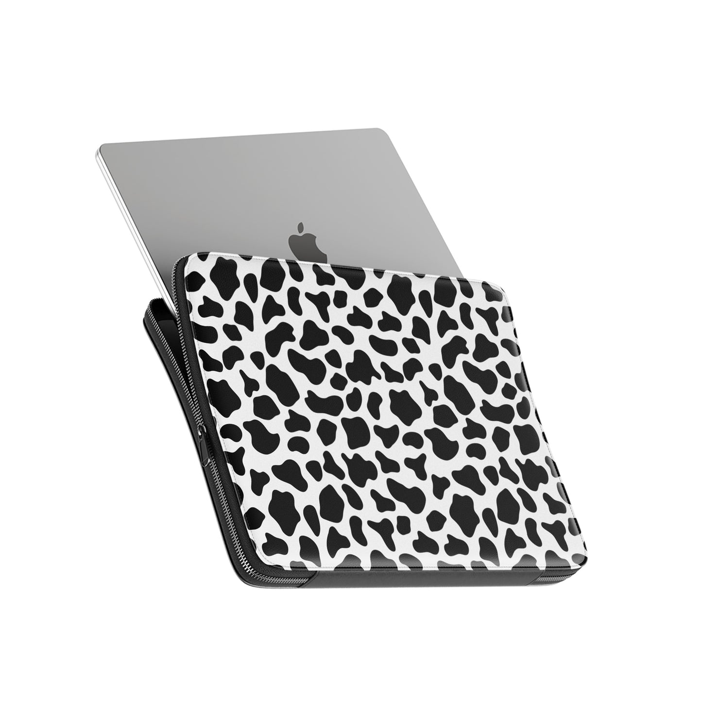 Black and white cow print pattern on Mootique Noir laptop sleeve with modern monochrome aesthetic