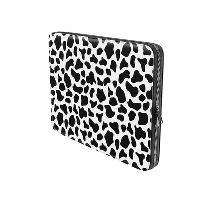 Black and white cow print pattern on Mootique Noir laptop sleeve with modern monochrome aesthetic