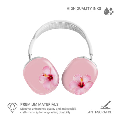 Pink hibiscus AirPods Max case with soft blush floral print on glossy headphone ear cup covers by Case & Charm.
