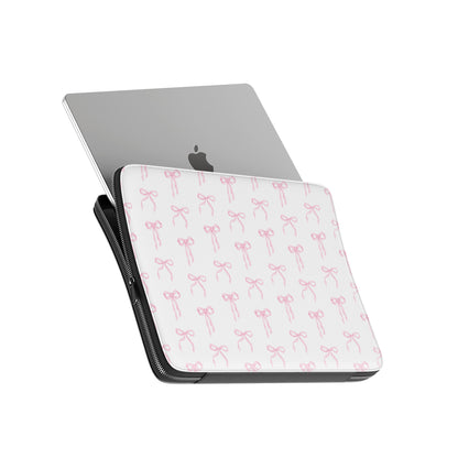 White laptop sleeve with blush pink ribbon bow pattern and padded protective design