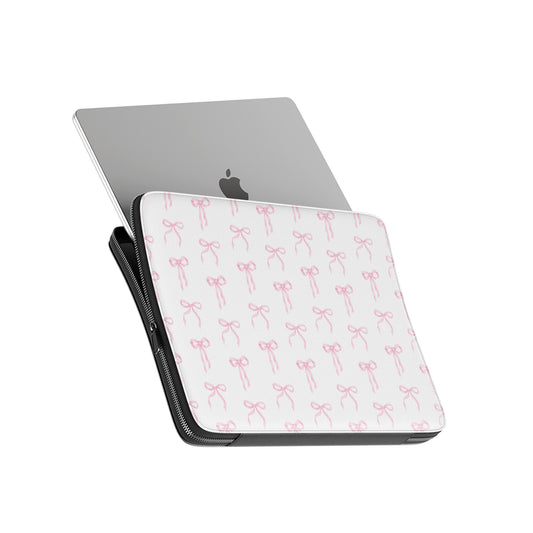 White laptop sleeve with blush pink ribbon bow pattern and padded protective design