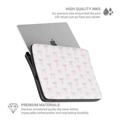 White laptop sleeve with blush pink ribbon bow pattern and padded protective design