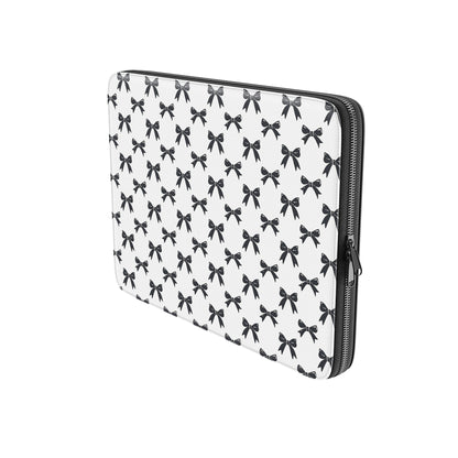 White laptop sleeve with black bow pattern and padded protective design