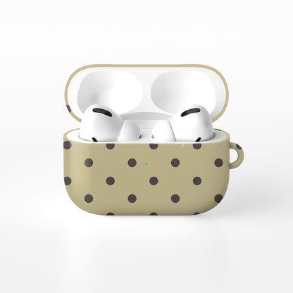 Cocoa Drops AirPods Case featuring small, evenly spaced cocoa-brown polka dots on a creamy vanilla background.