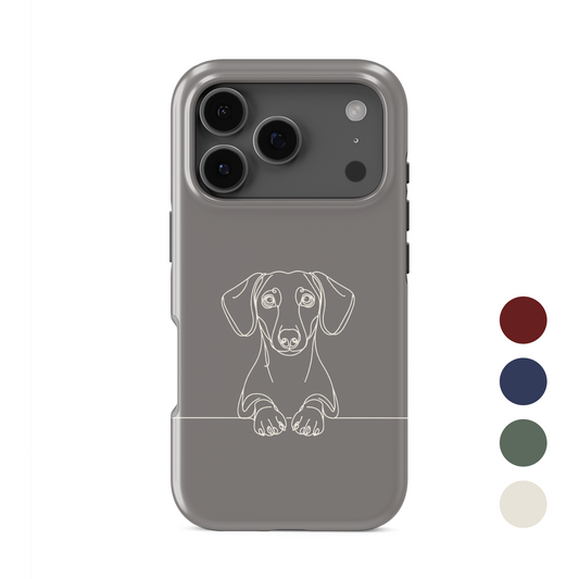 Cream MagSafe Tough phone case with black Dachshund line art, long ears and paws resting on a fine horizontal line.