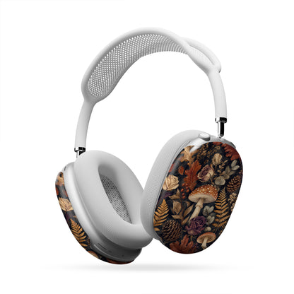 Woodland Forage AirPods Max ear-cup shells with mushrooms, ferns, pinecones and botanical foliage on a dark woodland background.