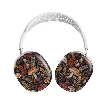 Woodland Forage AirPods Max ear-cup shells with mushrooms, ferns, pinecones and botanical foliage on a dark woodland background.