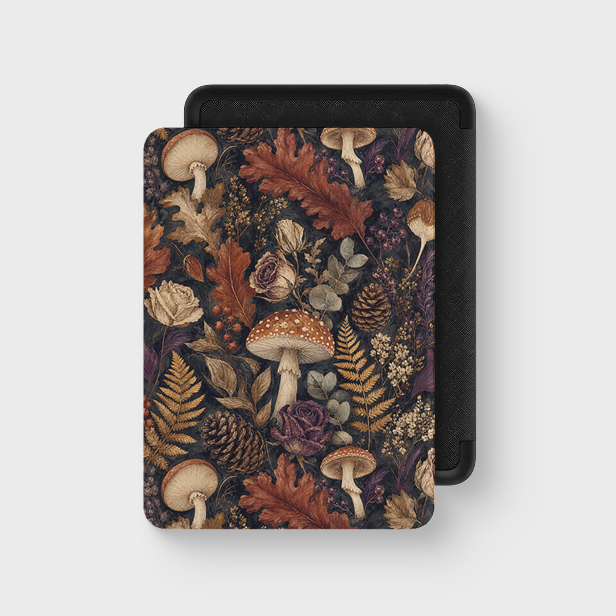 Woodland Forage Kindle case with mushrooms, ferns, pinecones and woodland foliage on a dark botanical background.