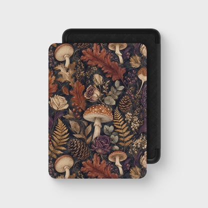 Woodland Forage Kindle case with mushrooms, ferns, pinecones and woodland foliage on a dark botanical background.