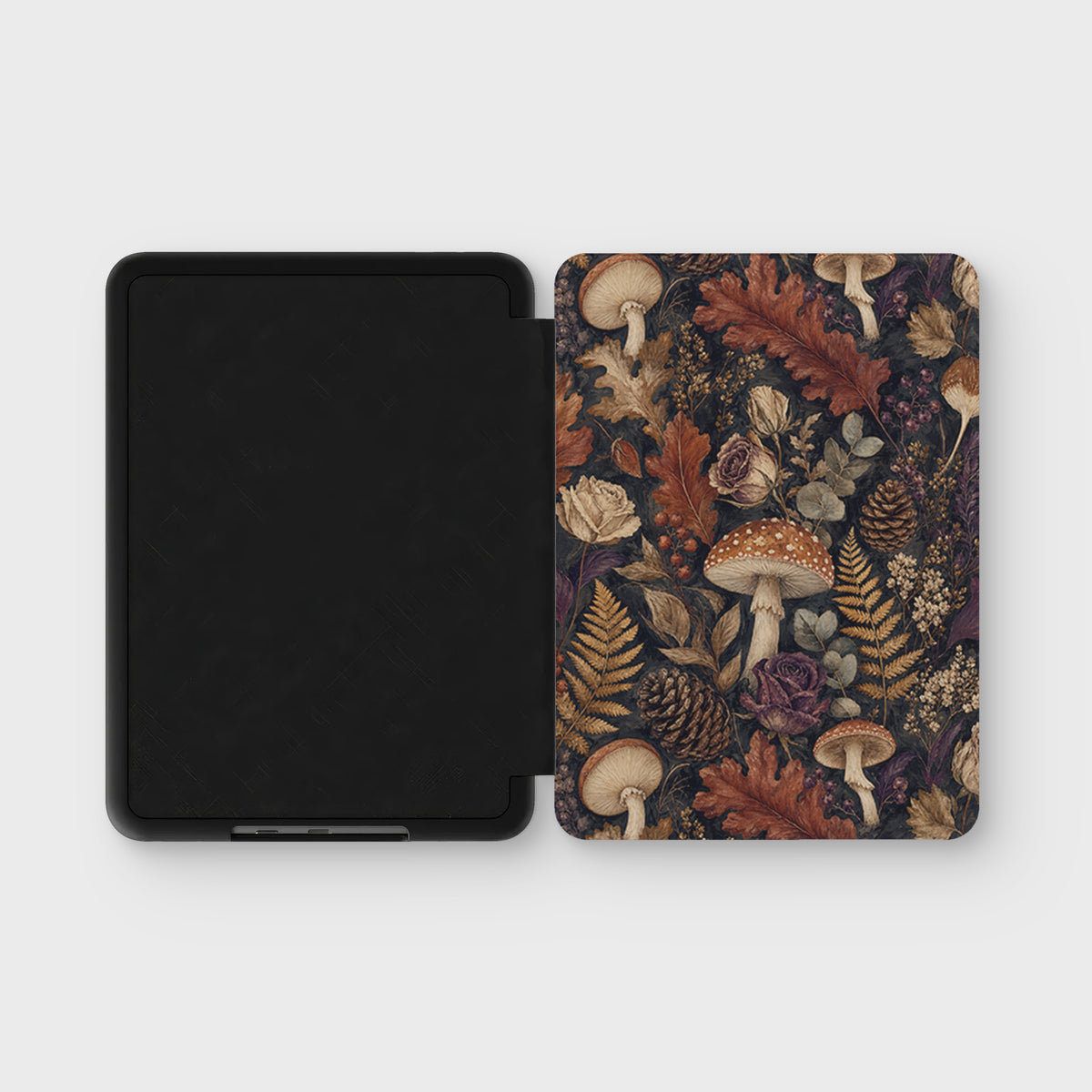 Woodland Forage Kindle case with mushrooms, ferns, pinecones and woodland foliage on a dark botanical background.