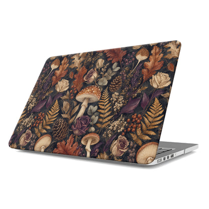 Woodland Forage MacBook shell with mushrooms, ferns, pinecones and botanical foliage on a dark woodland background.