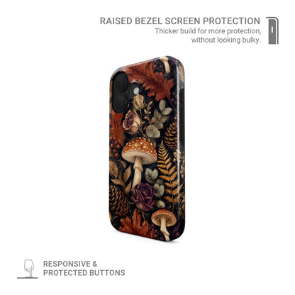 Woodland Forage MagSafe Tough phone case with mushrooms, ferns, pinecones and botanical foliage on a dark woodland background.