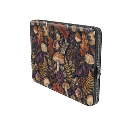 Woodland Forage laptop sleeve with mushrooms, ferns, pinecones and botanical foliage on a dark woodland background.