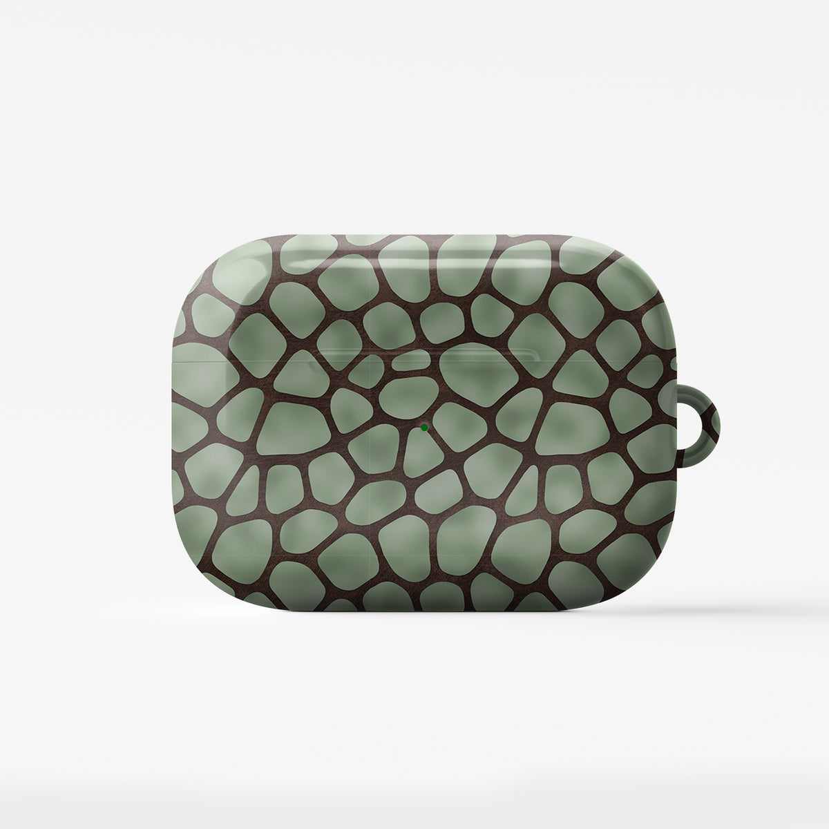 Mossy Mosaic AirPods Case with sage green giraffe spots outlined in chocolate brown from the Wild Atelier collection.