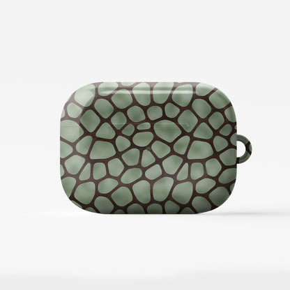 Mossy Mosaic AirPods Case with sage green giraffe spots outlined in chocolate brown from the Wild Atelier collection.