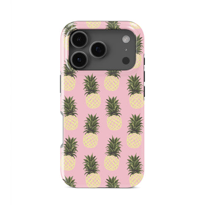 Pineapple tough phone case featuring yellow pineapple illustrations on a soft pink background with a fun tropical summer style.