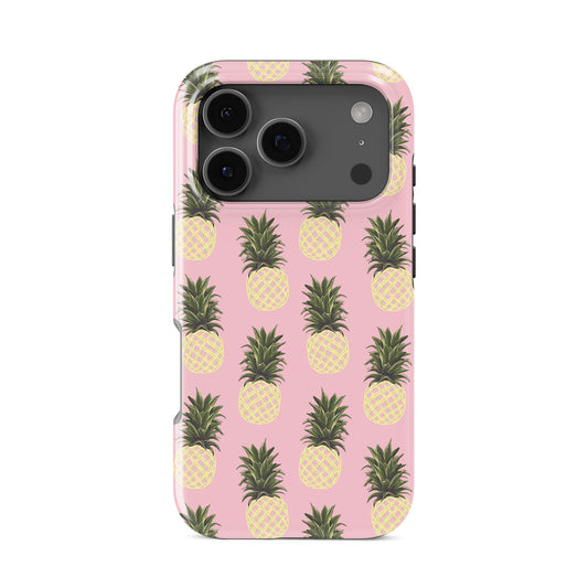 Pineapple tough phone case featuring yellow pineapple illustrations on a soft pink background with a fun tropical summer style.