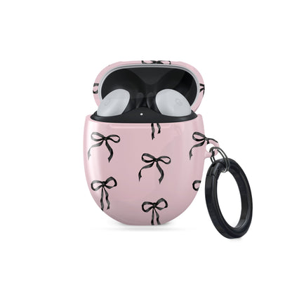 Burga Google Pixel Buds case in Ribbon Reverie design with black satin bows on a blush-pink background, slim and stylish coquette-inspired cover.