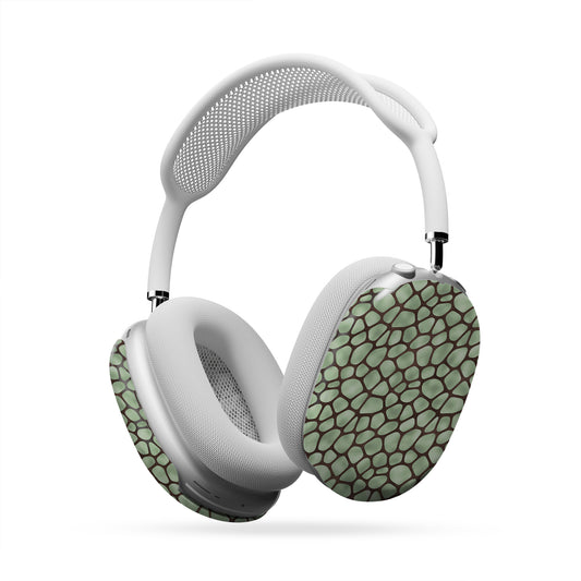 Mossy Mosaic AirPods Max Covers with sage green giraffe spots outlined in chocolate brown from the Wild Atelier collection.