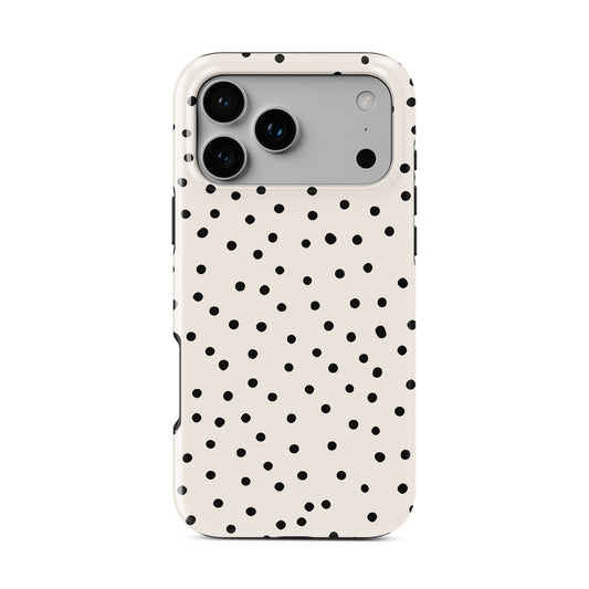 Cream polka dot tough phone case with black scattered dots on neutral background