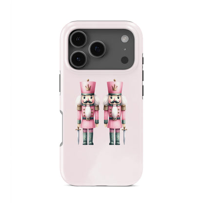 Glossy tough phone case with two pink Nutcracker soldiers on a blush background, dual layer style, Case & Charm Sugarplum Soldiers design