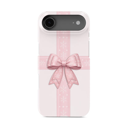 Blush pink ribbon crossing with large satin bow and white snowflakes on a soft pastel background, Protective Phone Case By Case & Charm “Winter’s Gift”