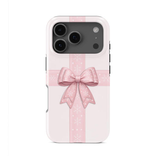 Glossy tough phone case with blush ribbon and large pink bow with white snowflakes on a soft pastel background, Case & Charm Winter’s Gift design